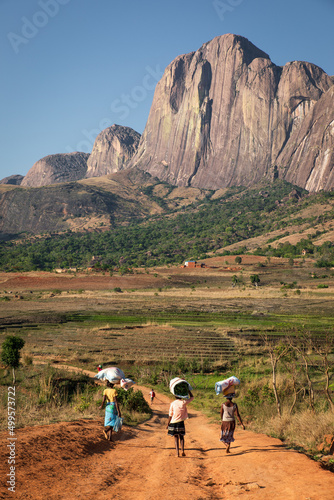 Tsaronaro rock formation in Madagascar south, africa, with african women carrying food to the village, red sand, beautiful mountain know for adventure tourism and climbing, near the RN7 photo