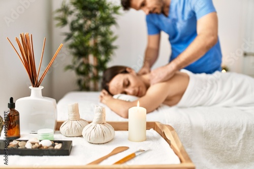 Young woman relaxed reciving back massage at beauty center. photo