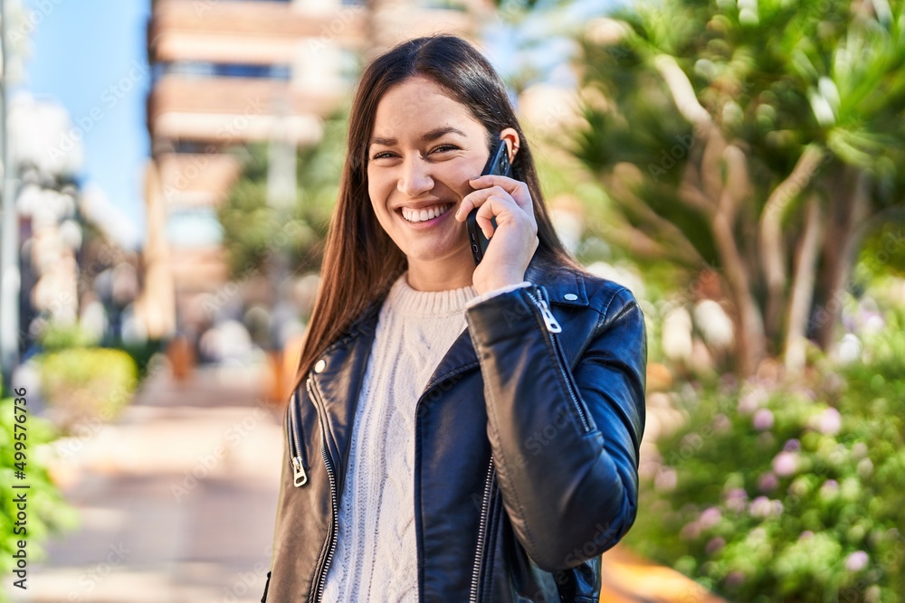 Young woman smiling confident talking on the smartphone at park Young woman smiling confident talking on the smartphone at park