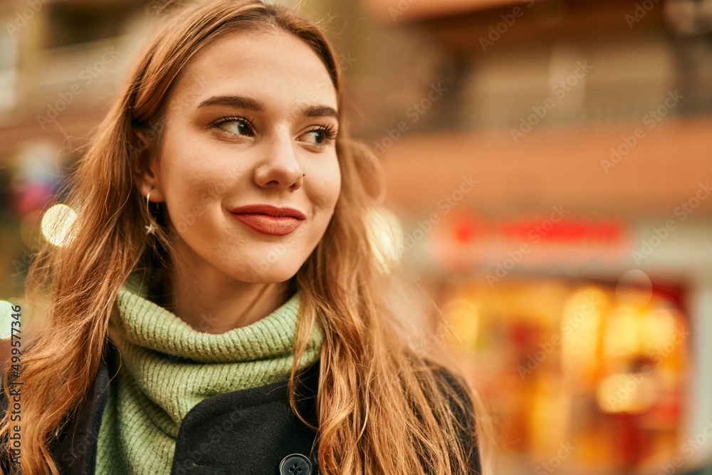 Young blonde girl smiling happy standing at the city. Young blonde girl smiling happy standing at the city.
