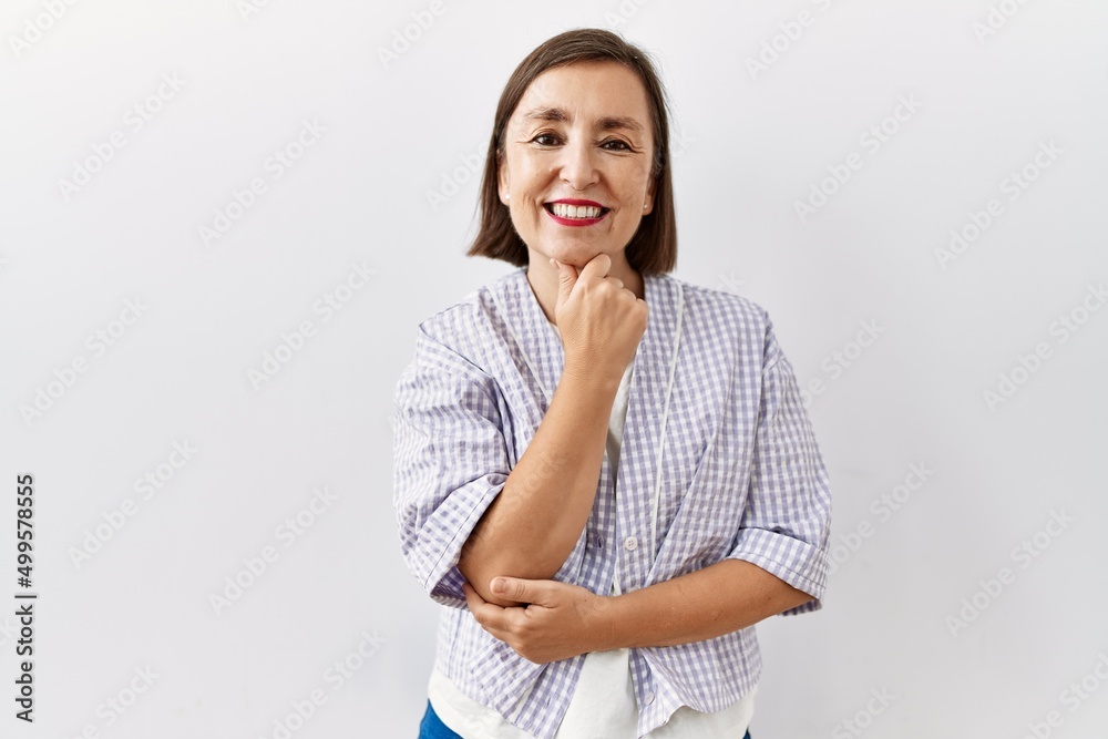 Beautiful middle age hispanic woman standing over isolated background cutting throat with hand as knife, threaten aggression with furious violence
