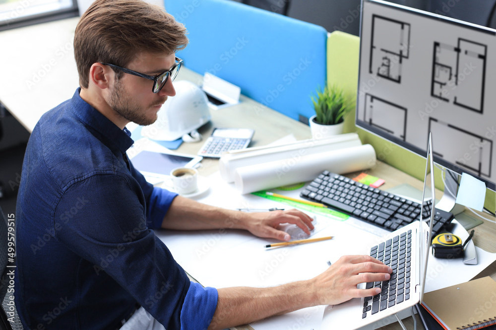 Shot of a handsome male architect working on a design in his office.