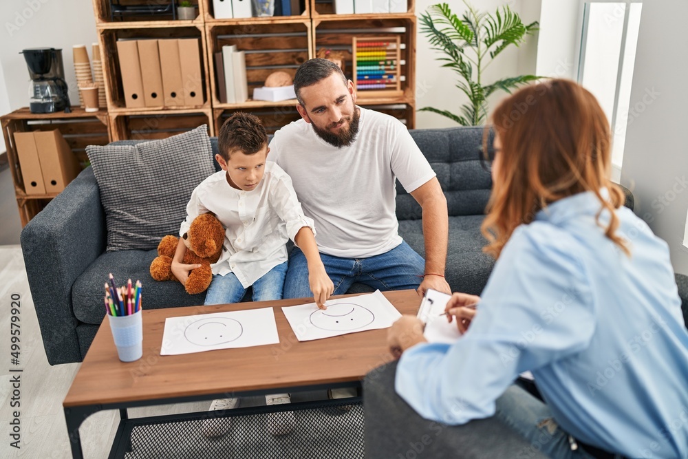 Family having psychology session choosing emotion emoji draw at psychology center Family having psychology session choosing emotion emoji draw at psychology center