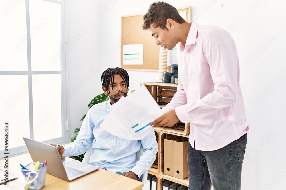 Two men business workers discussing working at office Two men business workers discussing working at office