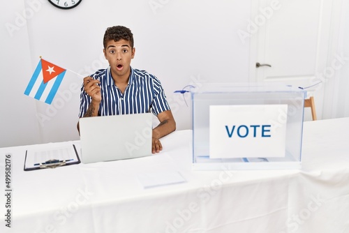 Photography Young handsome hispanic man at political campaign election holding cuba flag sca