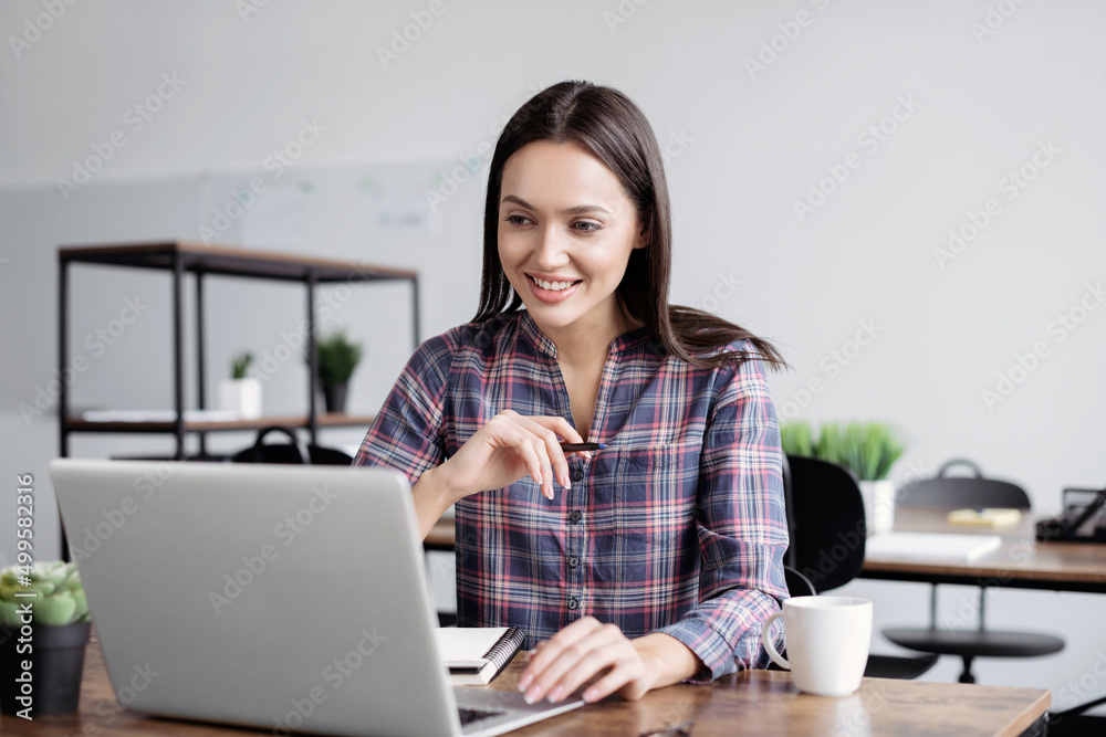 Young woman using laptop computer at office. Student girl working at class. Work or study from home, freelance, business, lifestyle concept Young woman using laptop computer at office. Student girl working at class. Work or study from home, freelance, business, lifestyle concept