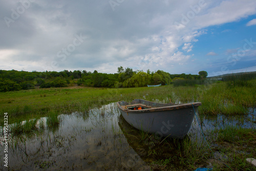 Boats stand by the lake, straws in the back. Eber Lake in Turkey. photo