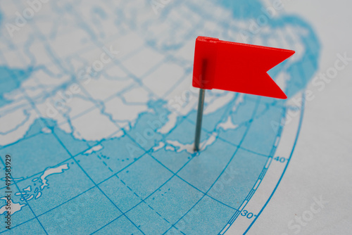 Breaking news from Japan concept. Red flag on map of Japanese islands. Earthquake or tsunami alert or some other accident attention.