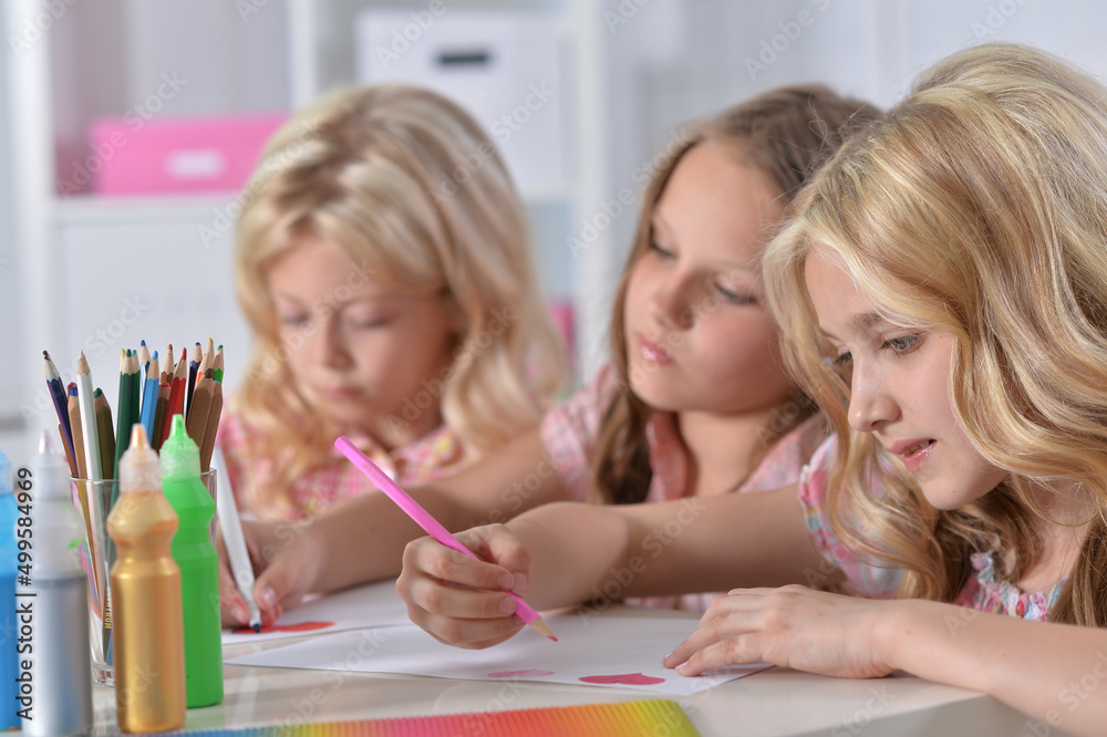 beautiful girls drawing with pencils at desk beautiful girls drawing with pencils at desk