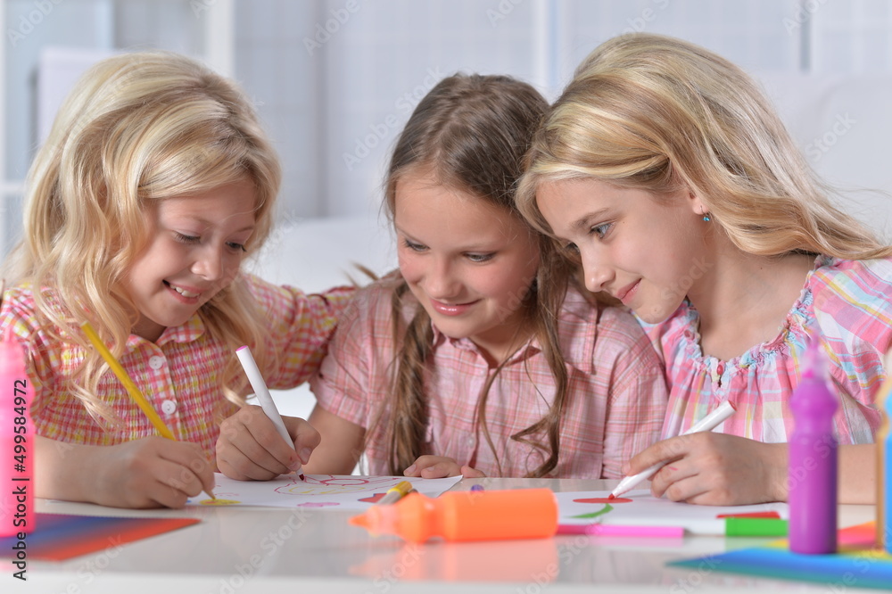 beautiful girls drawing with pencils at desk beautiful girls drawing with pencils at desk