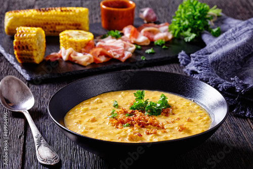 corn chowder in bowl on table, top view