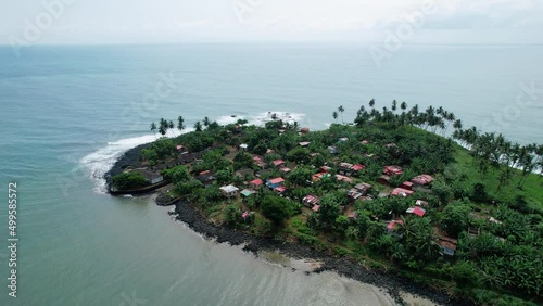 Aerial view around a town at the Baia da Praia do Rei agua Ize, in Sao Tome, Africa - orbit, drone shot photo