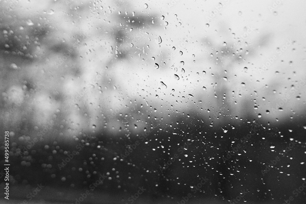 Raindrops on window glass with blur background