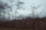 Raindrops on window glass with blur background