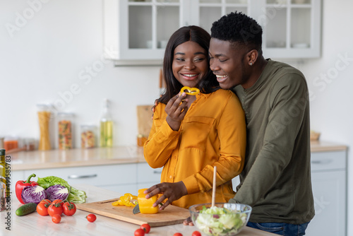 Cheerful Young Black Spouses Preparing Healthy Meal Together In Kitchen
