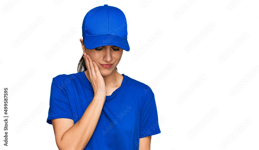 Young hispanic girl wearing delivery courier uniform touching mouth with hand with painful expression because of toothache or dental illness on teeth. dentist Young hispanic girl wearing delivery courier uniform touching mouth with hand with painful expression because of toothache or dental illness on teeth. dentist