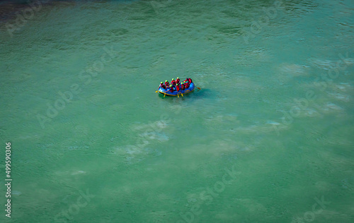 raft boat with people at the middle of ganges river from top angle