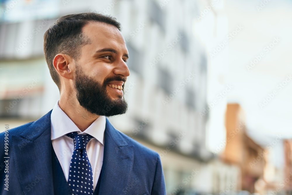 Fototapeta premium Young businessman smiling happy standing at the city.
