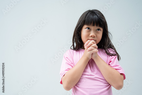 kid is praying, hands folded in prayer