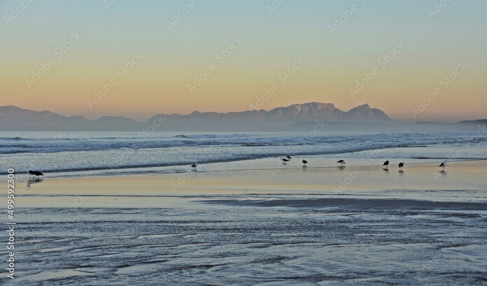 Landscape with a beautiful sunrise over the beach in Strand and the False Bay