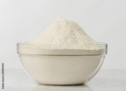 flour in a transparent bowl on a white background