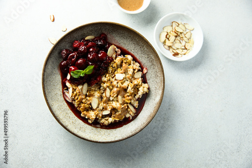 Healthy oatmeal porridge with cherries and almond photo