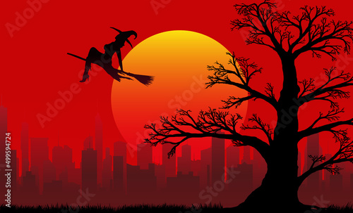 silhouette of a witch flying on a broomstick and an old branchy oak against the backdrop of the setting sun and the city in the distance