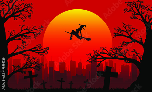 silhouette of a witch flying on a broomstick and old branchy oaks near the cemetery against the backdrop of the setting sun and the city in the distance
