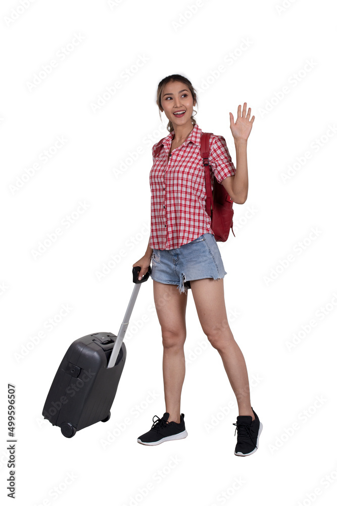 Female tourist stands with luggage on the journey while waving her han Female tourist stands with luggage on the journey while waving her han