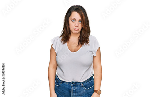 Young plus size woman wearing casual white t shirt depressed and worry for distress, crying angry and afraid. sad expression.