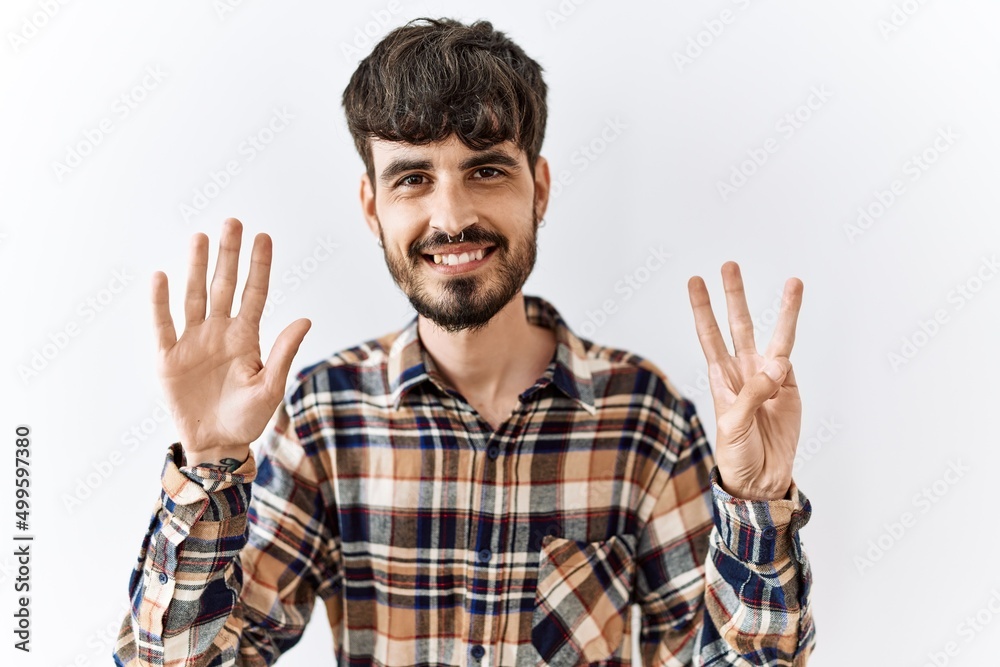 Hispanic man with beard standing over isolated background showing and pointing up with fingers number eight while smiling confident and happy. Hispanic man with beard standing over isolated background showing and pointing up with fingers number eight while smiling confident and happy.