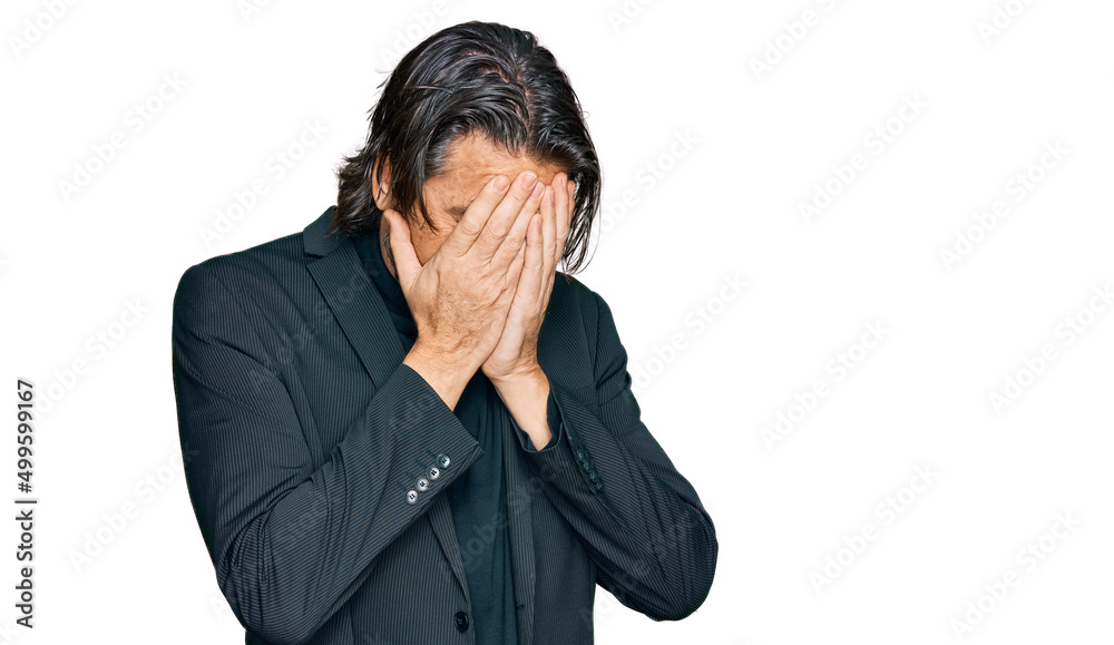 Middle age handsome man wearing business clothes with sad expression covering face with hands while crying. depression concept. Middle age handsome man wearing business clothes with sad expression covering face with hands while crying. depression concept.