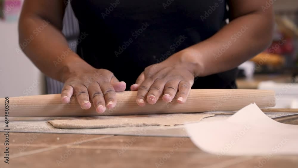 Using a rolling pin to roll out matzah bread or Passover bread out before baking Using a rolling pin to roll out matzah bread or Passover bread out before baking