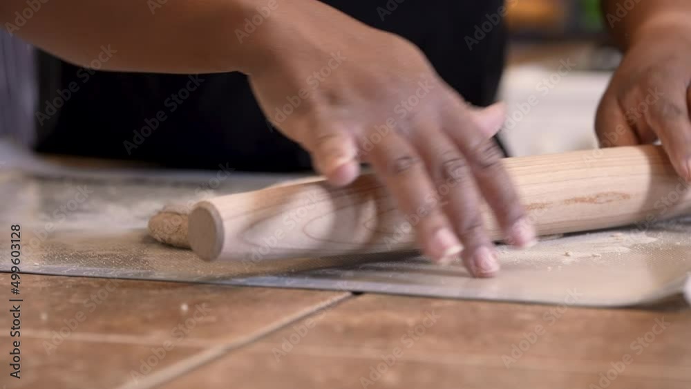 Rolling out Passover dough to flatten and bake into Matzah bread Rolling out Passover dough to flatten and bake into Matzah bread