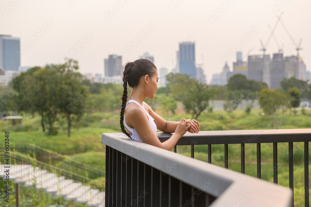 A young fitness woman in sportswear using smart watch while exercising in city park, Healthy and Lifestyles. A young fitness woman in sportswear using smart watch while exercising in city park, Healthy and Lifestyles.
