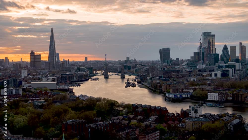 Wide, panoramic day to night time lapse view of the modern cityscape of London, England, with street and river traffic Wide, panoramic day to night time lapse view of the modern cityscape of London, England, with street and river traffic