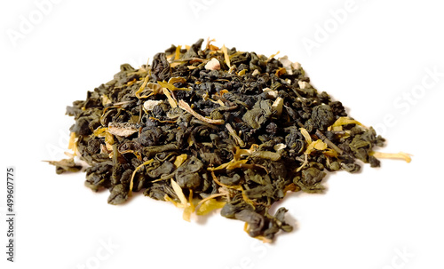 Fragrant dry green tea leaves with pieces of fruits and flowers