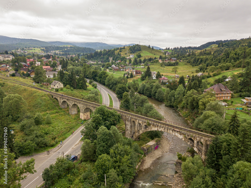 Fototapeta premium Old railway bridge in the mountains. Ukrainian Carpathians. Aerial drone view.
