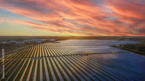 aerial view of solar panels on green lawn. drone shot, bird's eye