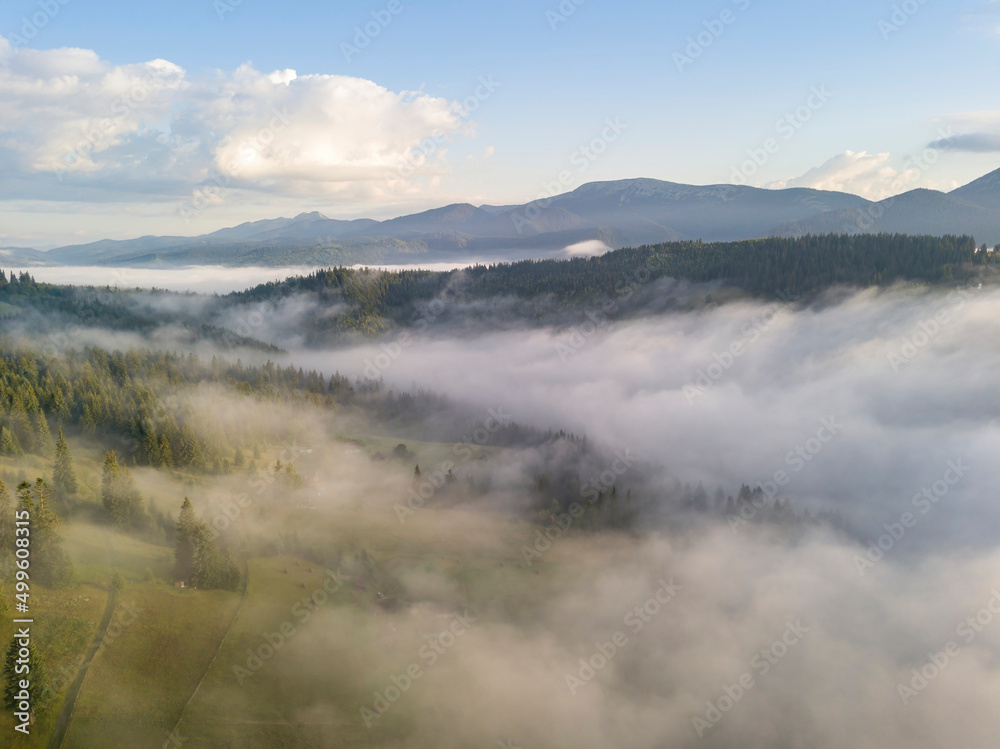 Green mountains of the Ukrainian Carpathians in the morning fog. Aerial drone view.