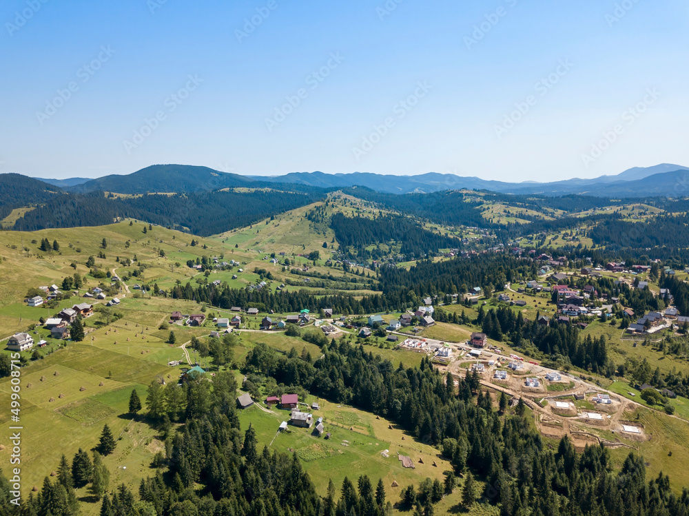 Fototapeta premium Mountain settlement in the Ukrainian Carpathians. Aerial drone view.