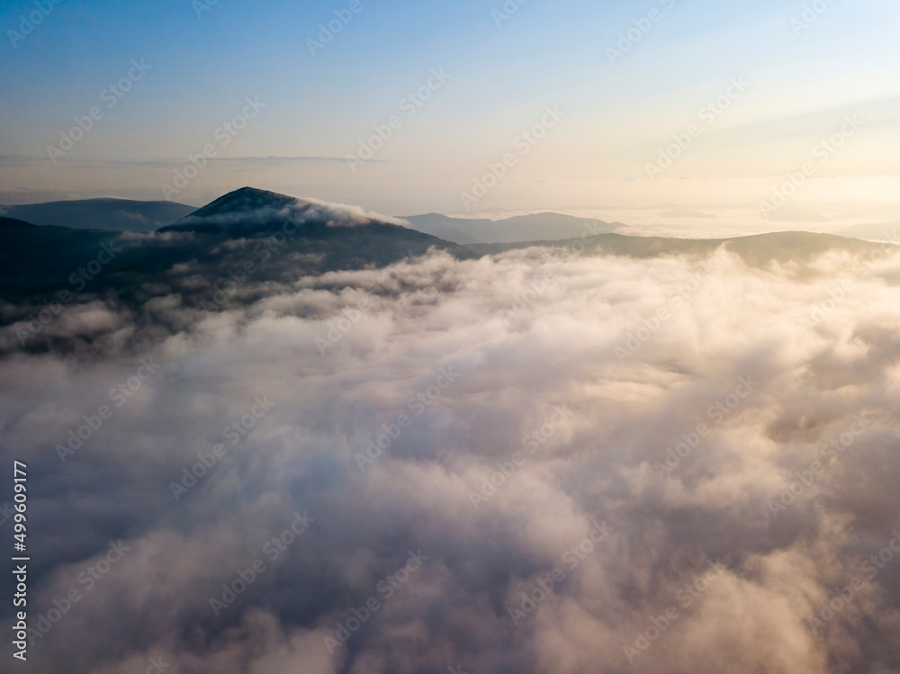 Flight over fog in Ukrainian Carpathians in summer. Mountains on the horizon. Aerial drone view. Flight over fog in Ukrainian Carpathians in summer. Mountains on the horizon. Aerial drone view.