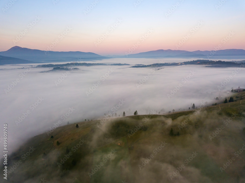 Sunrise over the fog in the Ukrainian Carpathians. Aerial drone view.