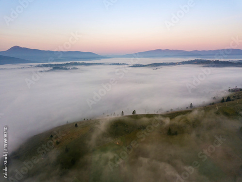 Sunrise over the fog in the Ukrainian Carpathians. Aerial drone view.