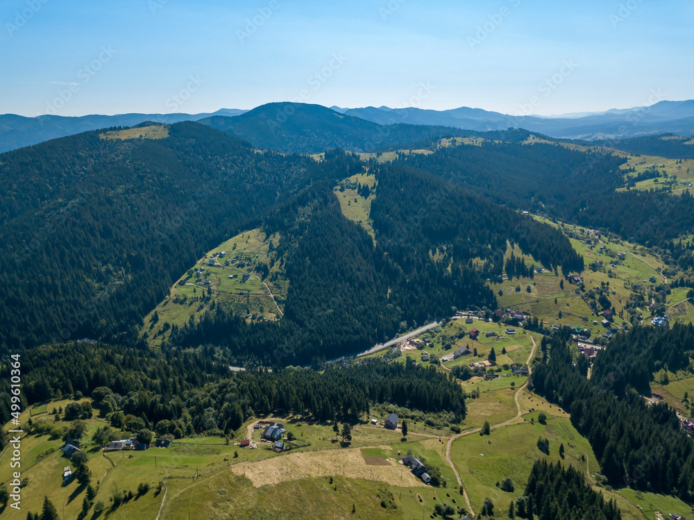 Fototapeta premium Green mountains of Ukrainian Carpathians in summer. Sunny clear day. Aerial drone view.