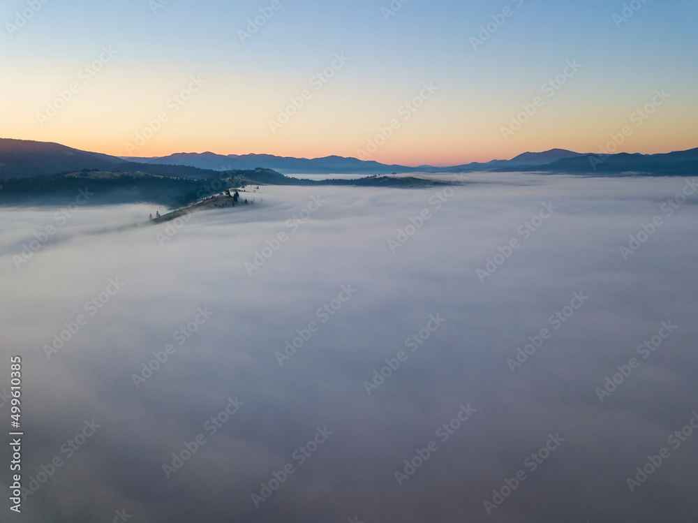 Sunrise over the fog in the Ukrainian Carpathians. Aerial drone view. Sunrise over the fog in the Ukrainian Carpathians. Aerial drone view.