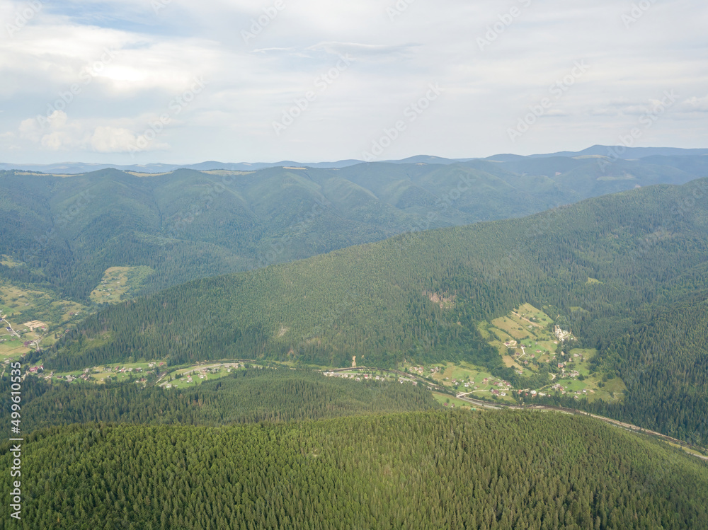 Fototapeta premium Green mountains of Ukrainian Carpathians in summer. Aerial drone view.