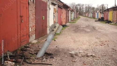 Wallpaper Mural Close-up view 4k stock video footage of real unexploded military missile, torpedo or shell stuck in ground near doors of garages outdoors. Moments of dreadful war of Russia against Ukraine in 2022 Torontodigital.ca