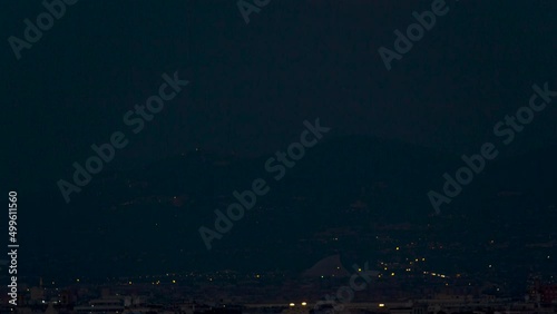 Day-To-Night timelapse of the Super-Moon rising over the mountains at dusk photo