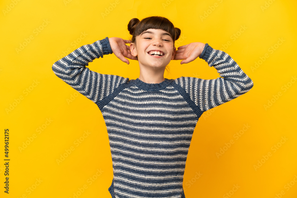 Little caucasian girl isolated on yellow background laughing Little caucasian girl isolated on yellow background laughing